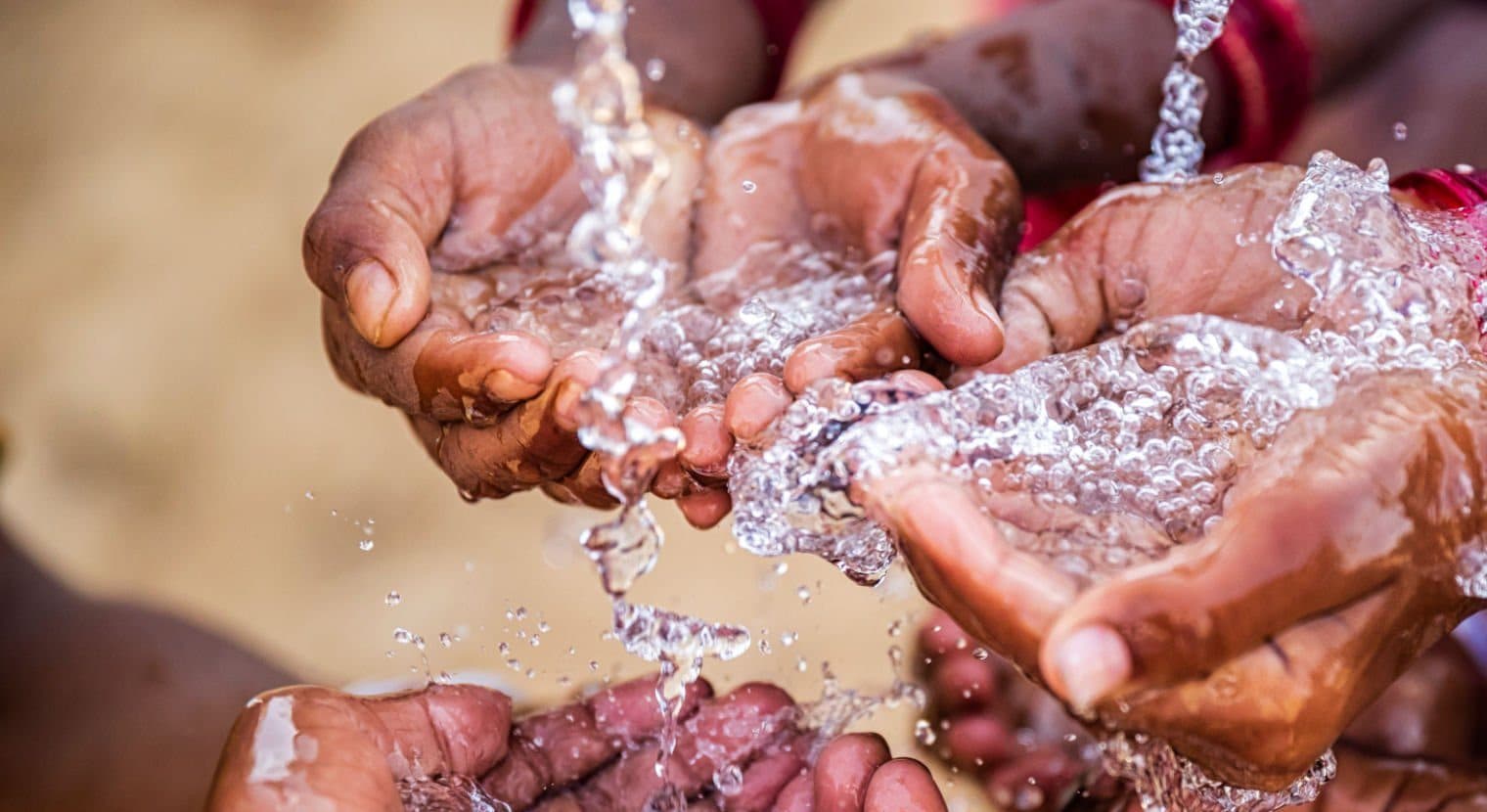 Hands catching clean flowing water